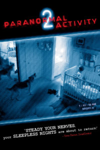 Promotional poster for PARANORMAL ACTIVITY 2 featuring Abby, the family dog barking in the direction of the connecting doorway between baby Hunter's room and the bathroom while Hunter stands n his crib looking on