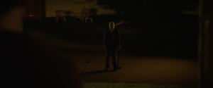 The Masked Man (a menacing Damien Maffei) stands outside the family trailer, axe in hand in Strangers: Prey at Night