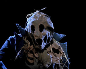 Bubba (Larry Drake) outfitted in his sackcloth scarecrow garb, faces the camera on a dark night in DARK NIGHT OF THE SCARECROW