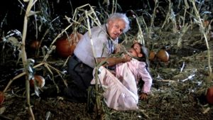 Otis (Charles Durning) terrorizes Marylee (Tonya Crowe} in a field in DARK NIGHT OF THE SCARECROW. He looms above her with a fistful of her dress as she screams in terror