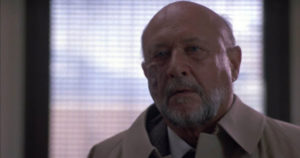 A burn-faced Dr. Loomis (Donald Pleasance) sets out to protect the town of Haddonfield once more in HALLOWEEN 4