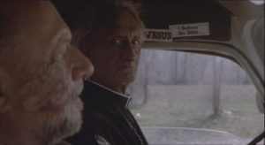 Loomis explains the evil of Michael Myers as he gets a ride in HALLOWEEN 4