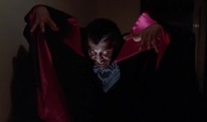Blacula (William Marshall) looms over with cape extended in Scream, Blacula, Scream