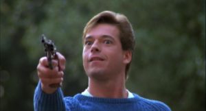 Ricky (Eric Freeman) points a gun at his neighbor on garbage day in Silent Night, Deadly Night 2