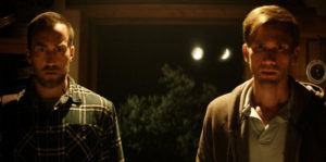 John (Aaron Moorhead) and Levi (Justin Benson) look on to something unusual in SOMETHING IN THE DIRT (2022)